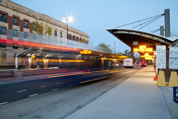 A bus at dusk with light streaks at the Central Campus Transit Center