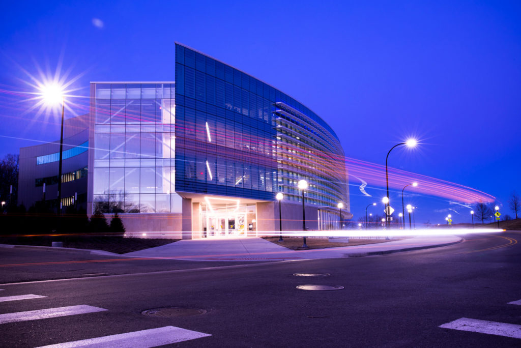 The modern glass Ford Robotics Building at night