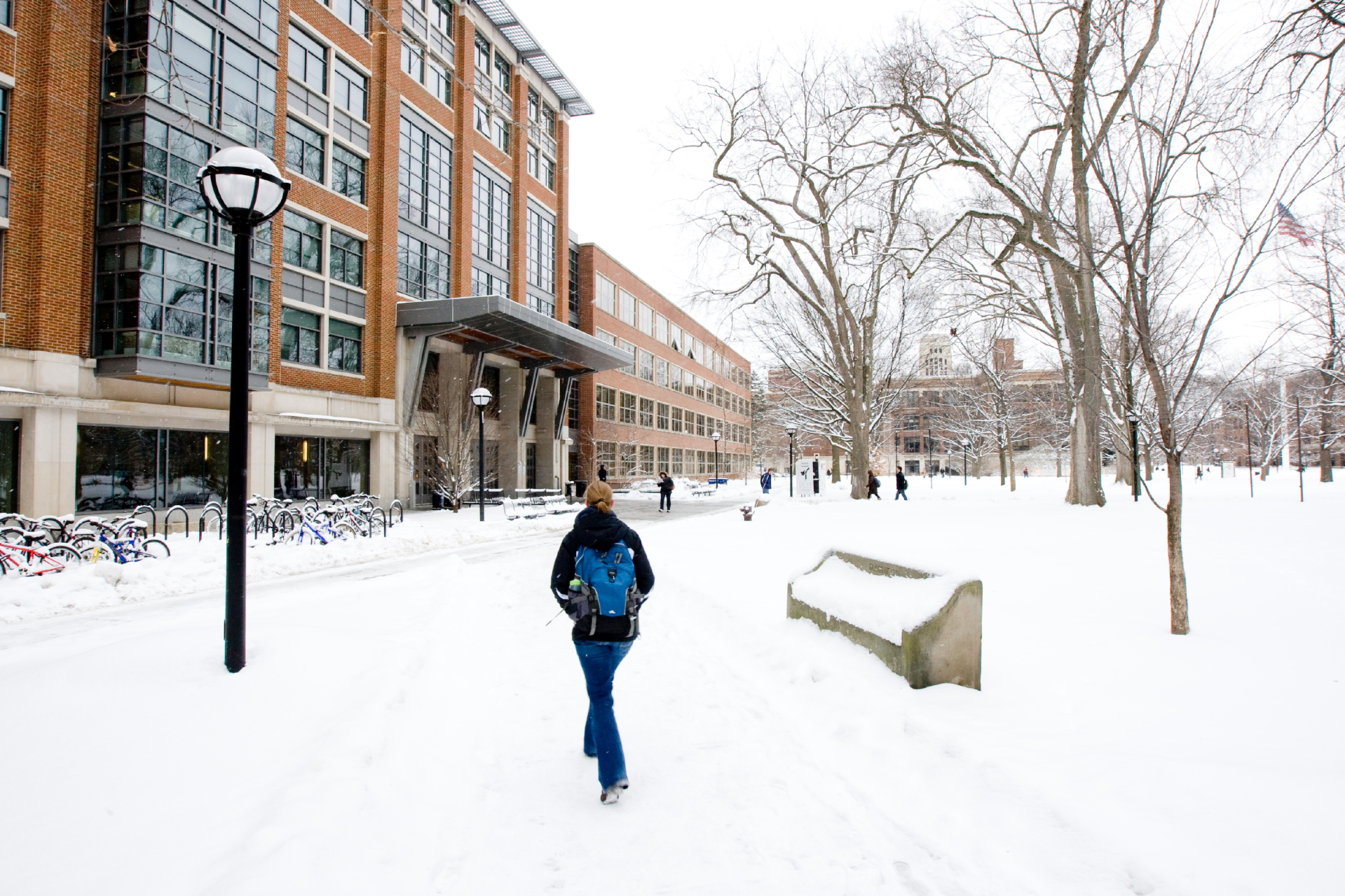 A person walking past Haven Hall in winter