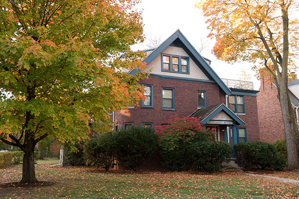 Exterior of Henderson House in the fall with leaves changing color