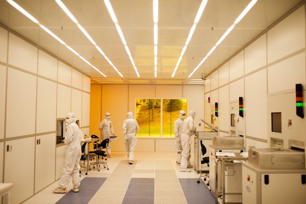 Resesarchers in hazmat suits in a lab