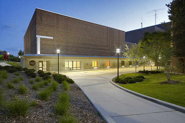 The east entrance of the brick EECS Building at dusk