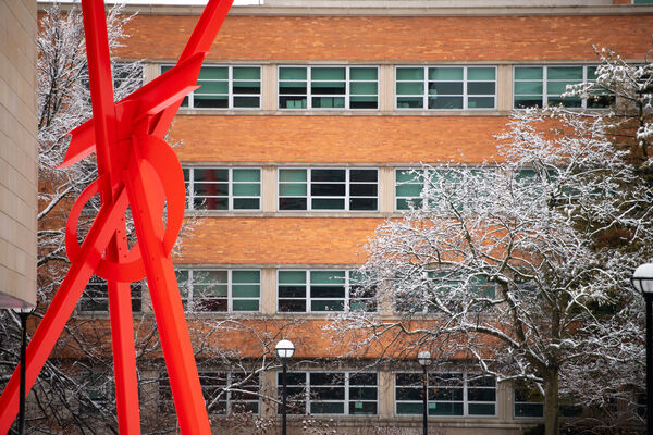 The orange brick LSA building with the large, bright red modern "Orion" sculpture in front of it