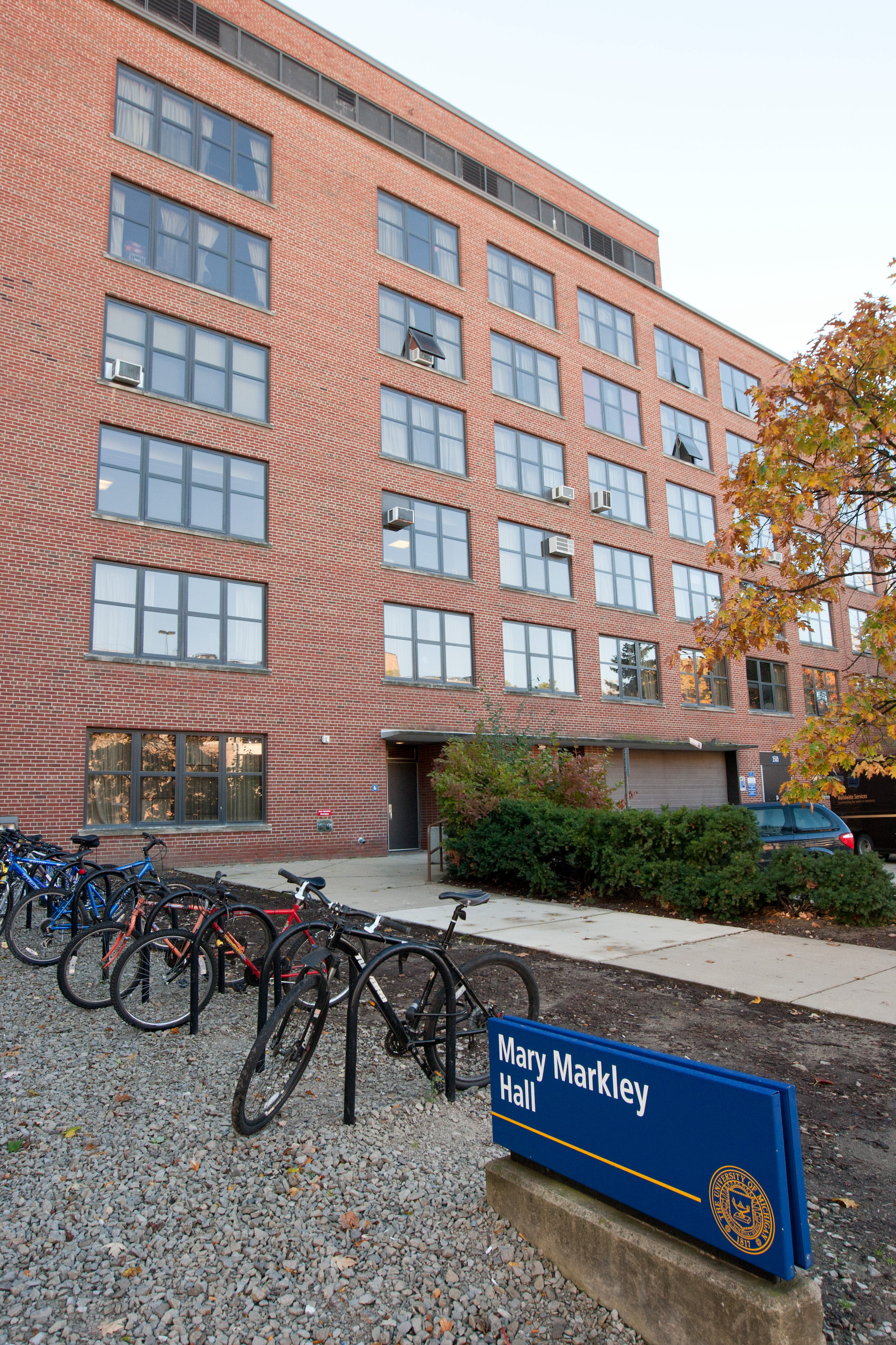 Front view of Markley Hall showing its campus sign and bike rack