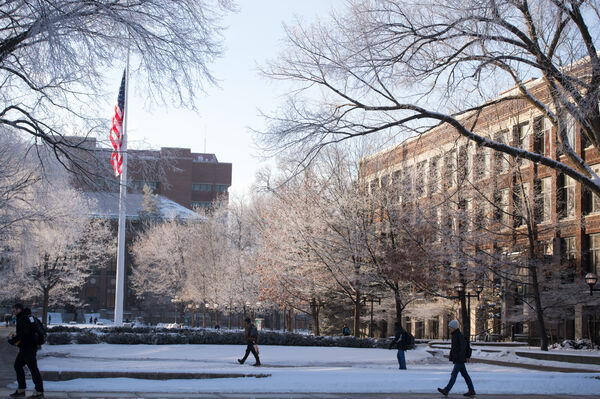 Students crossing the Diag by Hatcher Library and Mason Hall in the winter