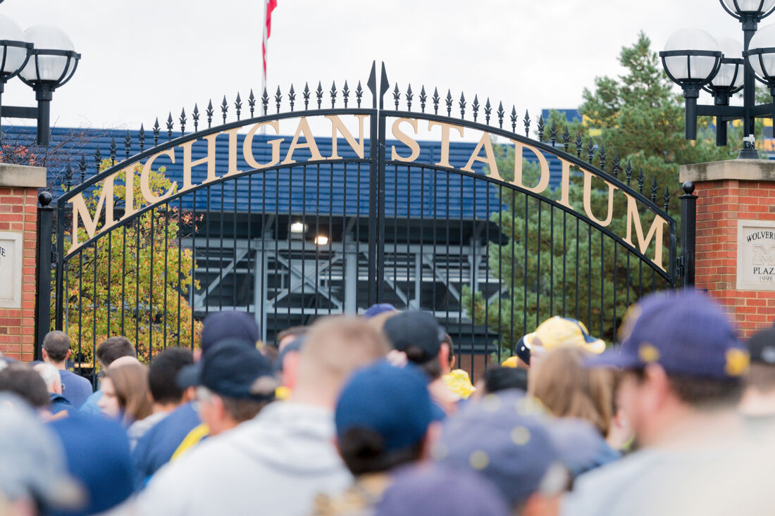 A crowd gathered outside of the gates of Michigan Stadium