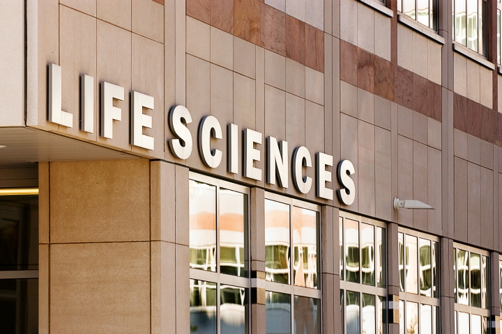 The marble exterior of the LSI building with "Life Sciences" in large letters above the entrance.