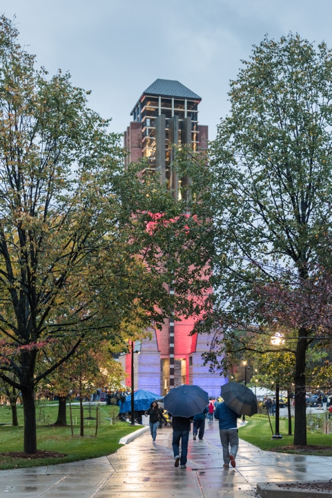 The tower illuminated with different colors at dusk