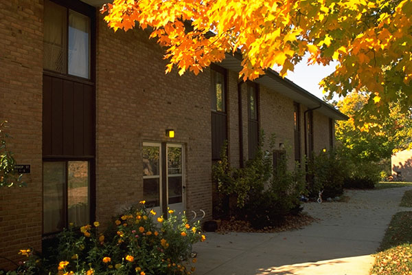 The brick exterior of Northwood II in the fall with orange leaves