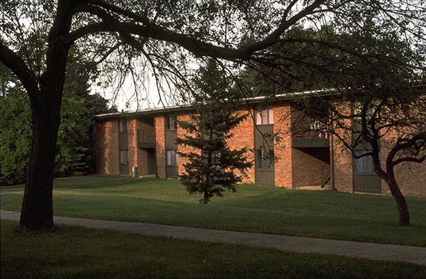 The brick exterior of Northwood II with pine and other trees