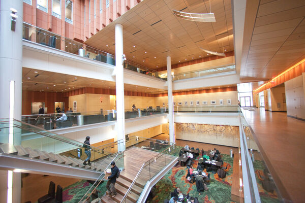 The center atrium of the Ross School of Business with warm wood and terracotta tones