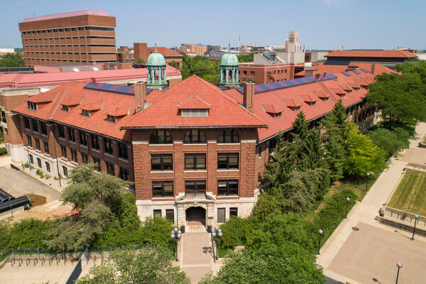 A bird's-eye view of West Hall with its terracotta roof and aged copper towers