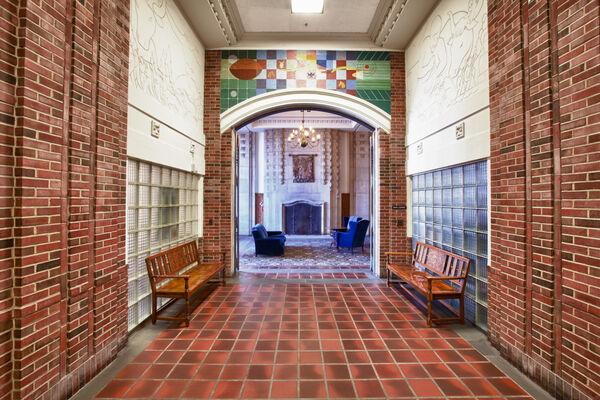 A hallway with brick and colorful tile
